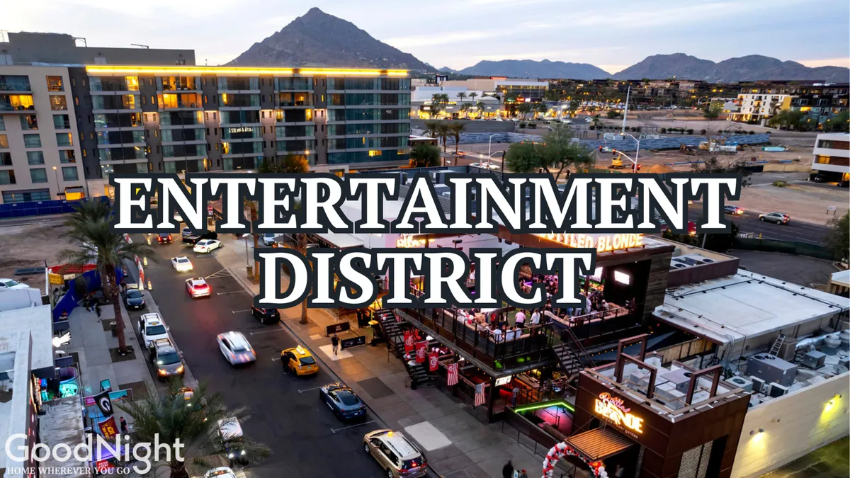 A vibrant exterior shot of a lively entertainment venue, with cars on the street and mountains visible in the background, capturing the excitement and energy of local Scottsdale nightlife.